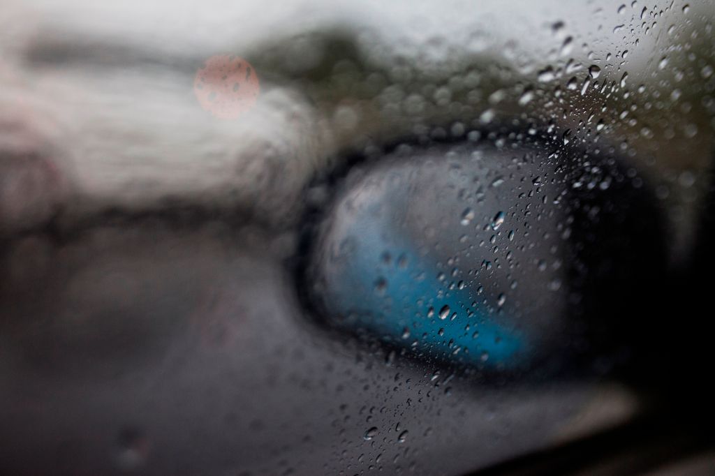 Raindrops fall on the window of a car