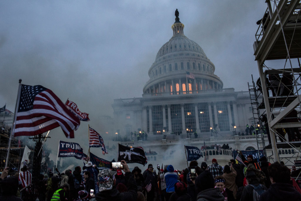 Security forces respond with tear gas after the US President...