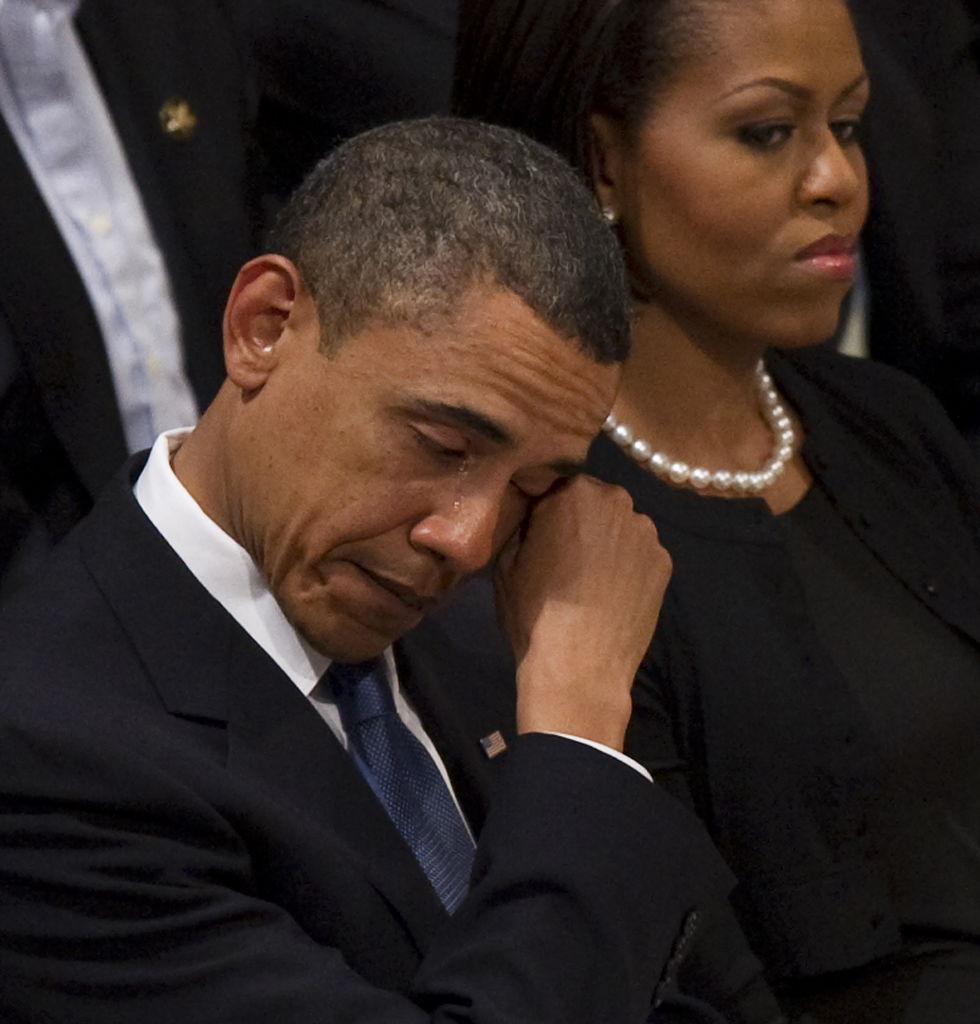 US President Barack Obama wipes away a t