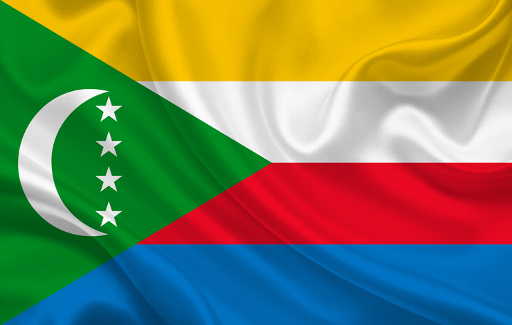 Comoros country flag on wavy silk fabric background panorama