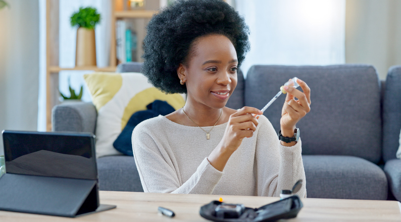 Woman, syringe and insulin in home, table and preparation for injection, healthcare or tablet for steps on telehealth app. African girl, needle and drugs for diabetes, wellness and pharma product