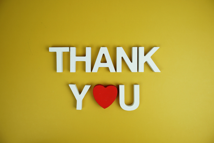 Thank You alphabet letters top view on yellow background